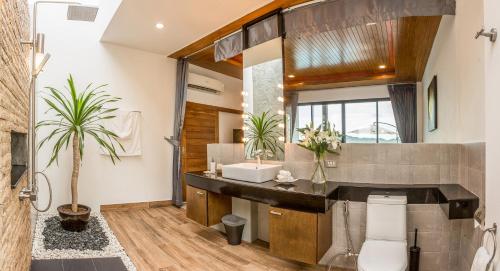 a bathroom with a sink and a mirror at Bliss Villas in Srithanu