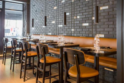 a row of tables and chairs in a restaurant at Radisson Blu Hotel, London Leicester Square in London