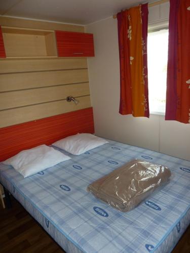 a bed with a plastic sheet on it in a room at Mobile Home Hanse in Boofzheim