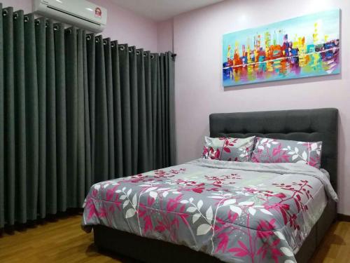 um quarto com uma cama com cortinas verdes e um quadro em Sekinchan Happiness Homestay em Sekincan