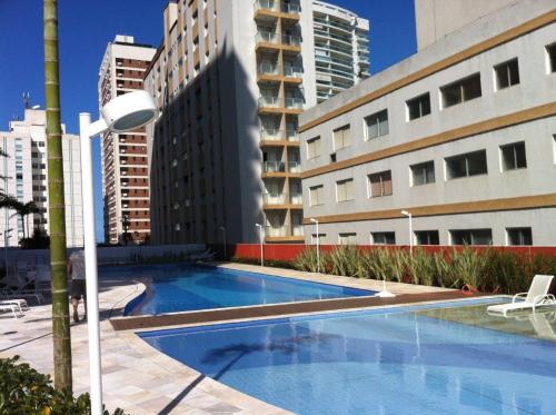a swimming pool in front of some buildings at Vista ao Mar & Lazer Total in Guarujá