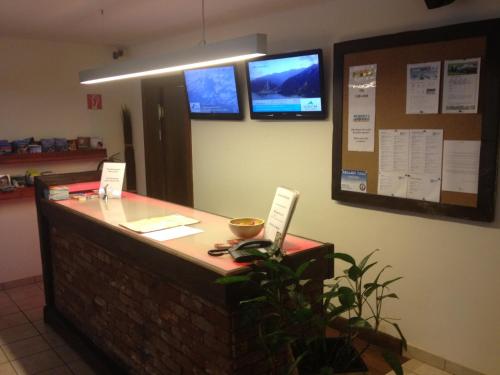 a reception desk with a laptop on top of it at Hotel Traube in Zell am See