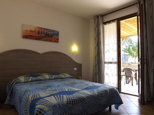a bedroom with a bed and a door to a patio at B&B Il Pizzagiallo in Massa Martana
