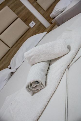 a stack of towels sitting on top of a bed at Apartments Sija in Ulcinj
