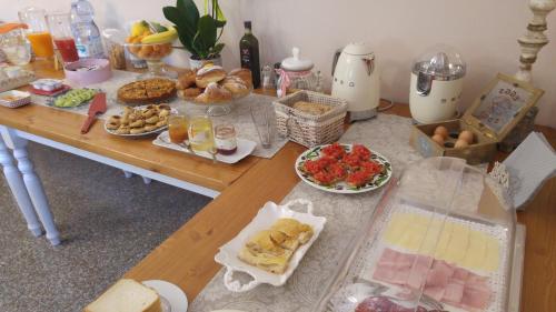 a table with many different types of food on it at Villa Mandrioli in Cecina