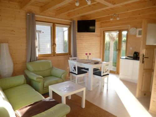 a living room with a couch and a table at Cztery Pory Roku in Trzęsacz