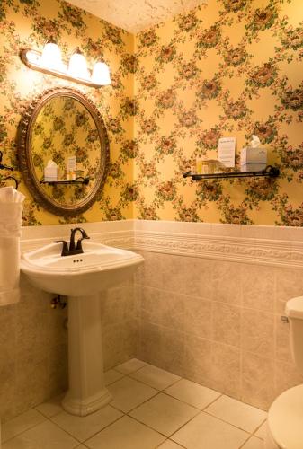 a bathroom with a sink and a mirror at Landoll's Mohican Castle in Loudonville