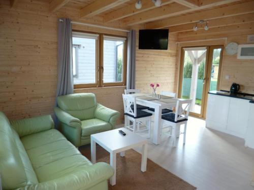 a living room with a white table and chairs at Cztery Pory Roku in Trzęsacz