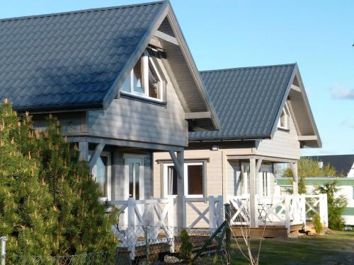 a house with a black roof at Cztery Pory Roku in Trzęsacz