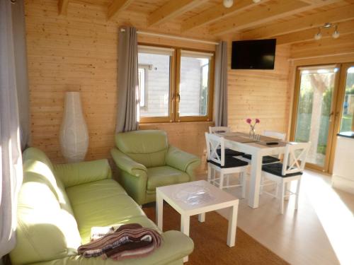 a living room with a couch and a table at Cztery Pory Roku in Trzęsacz