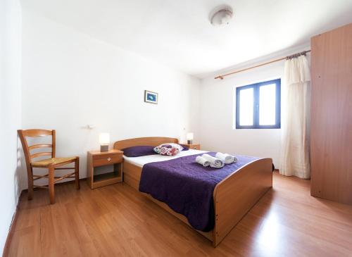 Ένα ή περισσότερα κρεβάτια σε δωμάτιο στο Apartments & Rooms Tina Drazica