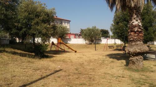 a park with a playground with a palm tree at Hotel Santa Caterina in Gizzeria
