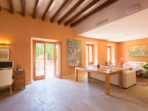a living room with a table and a couch at Ca' n Beia Suites - Adults Only in Alaró