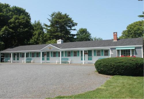 a large white house with blue accents at Mid-Town Motel in Boothbay Harbor
