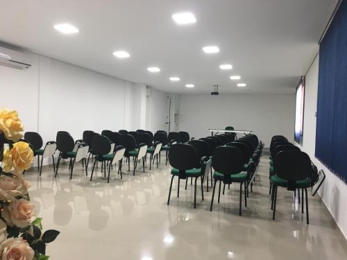 a room with rows of chairs in a room at Hotel Mares do Sul in Tramandaí