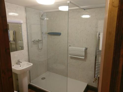 a bathroom with a glass shower and a sink at Wheyrigg Hall Hotel in Wheyrigg