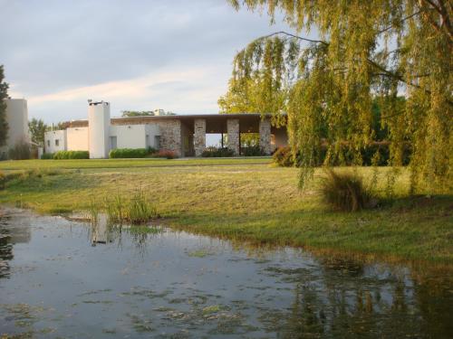 a view of the house from the pond at Hotel Boutique Posada Piedras Blancas in Santa Rosa
