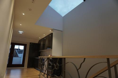 a kitchen with a glass ceiling and a counter at Feira Hostel & Suites in Santa Maria da Feira