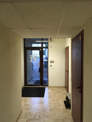 an empty hallway with a door to a building at Hotel Dorele in Montargis