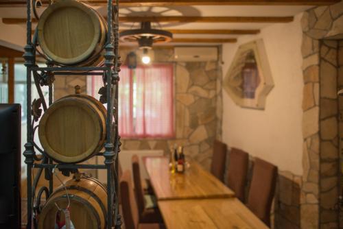 a dining room with a wooden table and some wine barrels at Apartmani Krgušić in Tivat