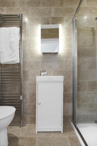 a bathroom with a toilet sink and a shower at Ocean Outlook - Broadstairs Best! in Broadstairs