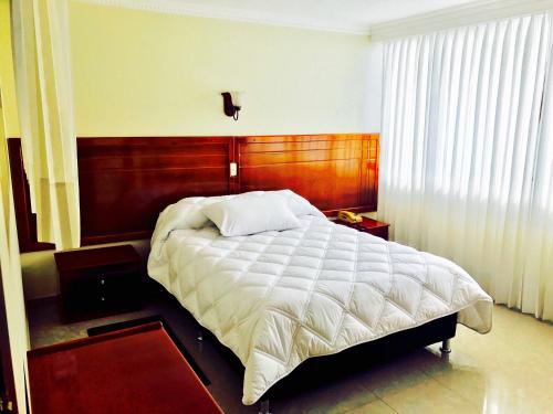 Postel nebo postele na pokoji v ubytování Hotel Azuay