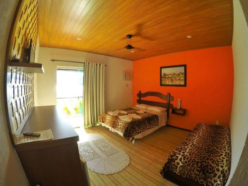 En eller flere senge i et værelse på Pousada da Praia