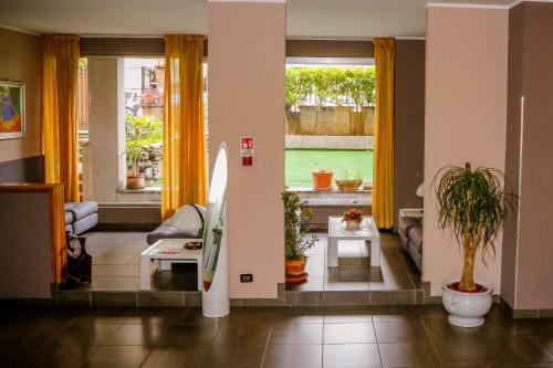 a living room with two windows and a couch at Hotel Giada in Turin
