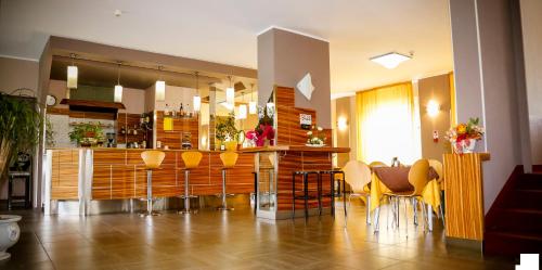 a kitchen with a bar with yellow bar stools at Hotel Giada in Turin