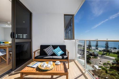 a living room with a couch and a table at Pacific Beach Resort in Mooloolaba