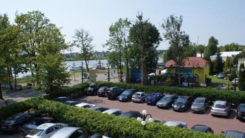 a row of cars parked in a parking lot at Dworek Morski SPA & Wellness in Mielno