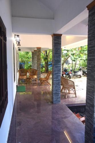 a living room with a fireplace and a patio at Marari Bethsaida Homestay in Shertallai