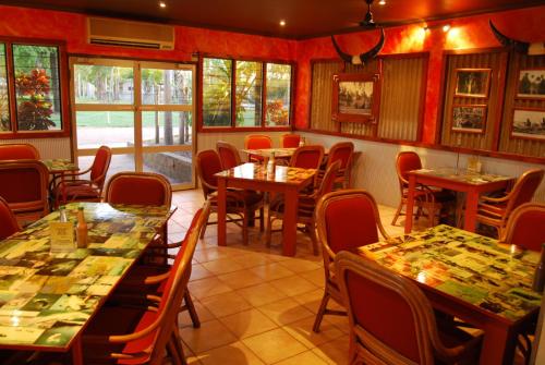 a restaurant with tables and chairs in a room at Point Stuart Wilderness Lodge in Point Stuart