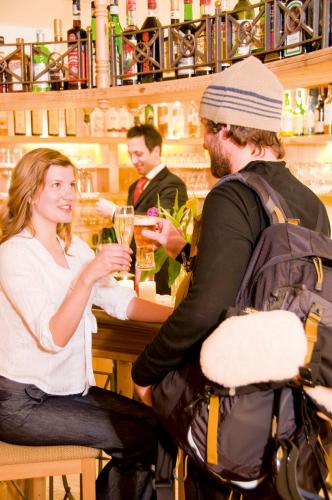 a group of people sitting at a bar at Boutique Hotel Diana in Madonna di Campiglio