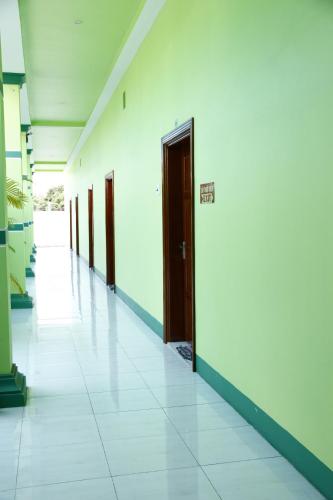 an empty hallway with doors on the wall and a tile floor at Tan My Thien Hotel in Tây Ninh