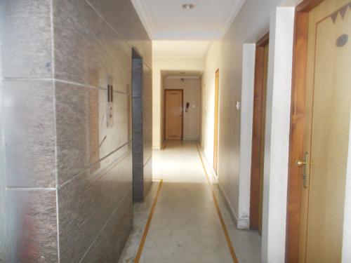 a hallway with a long hallway with a hallway at Modern Hotel in Bengaluru