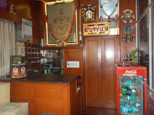 a kitchen with a counter and a refrigerator at Modern Hotel in Bangalore