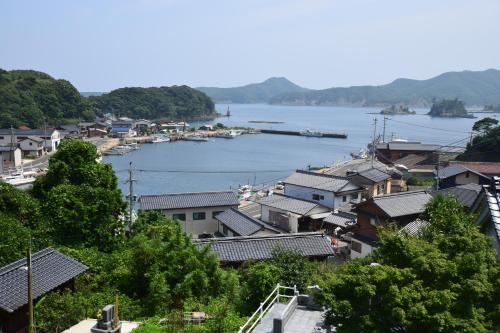 a view of a town with a river and houses at Minshuku Nishidomari in Tsushima