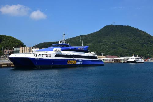 a large blue and white boat in the water at Minshuku Nishidomari in Tsushima