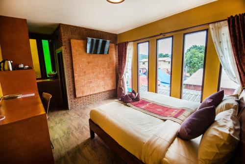 Postel nebo postele na pokoji v ubytování Pongphen Guesthouse - SHA Plus Certified