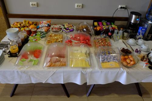 a table topped with plastic containers of fruits and vegetables at Hotel Dragalevtsi in Sofia