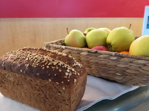 a loaf of bread and a basket of apples at Haus der Begegnung in Innsbruck