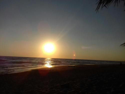 a sunset on a beach with the ocean at Ionion Star Hotel in Tholón