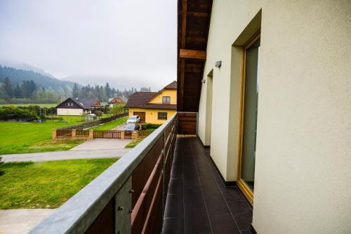 a balcony with a view of a house at Penzion U Barana in Trojanovice