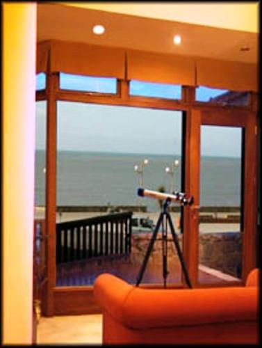 a view of the ocean from a room with a telescope at Hotel Amsterdam in Mar del Plata