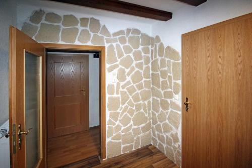 a room with a stone wall next to a door at Ferienwohnung Waldstraße in Waldsassen