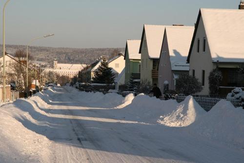 a street covered in snow next to houses at Ferienwohnung Waldstraße in Waldsassen