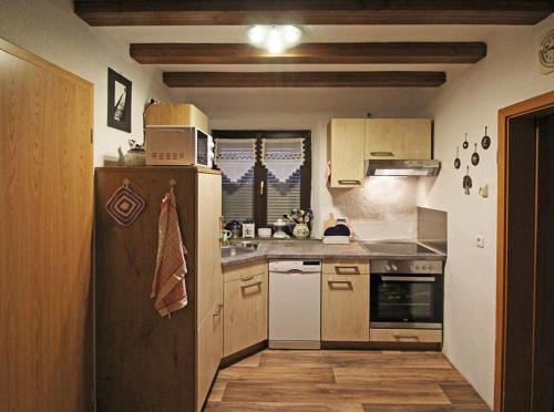 a small kitchen with a refrigerator and a sink at Ferienwohnung Waldstraße in Waldsassen