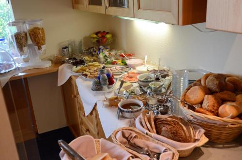 a table with a bunch of food and bread on it at Gästehaus Köglmaier in Kelheim