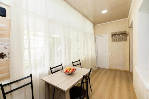 a dining room with a table with a bowl of fruit on it at Apartment in Cozy Little Yard in Tbilisi City